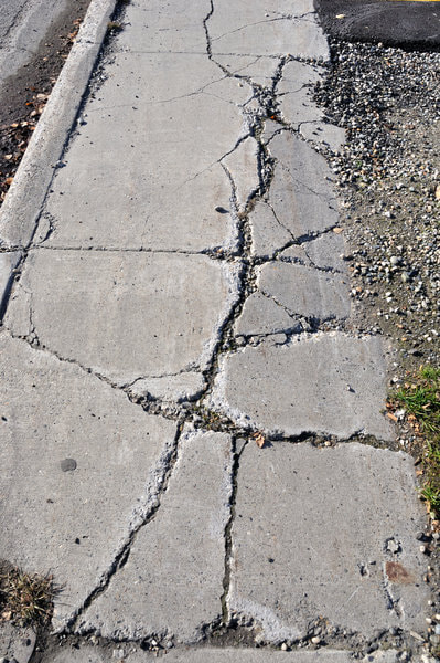 Concrete sidewalk in Abbotsford that needs to receive repairs.