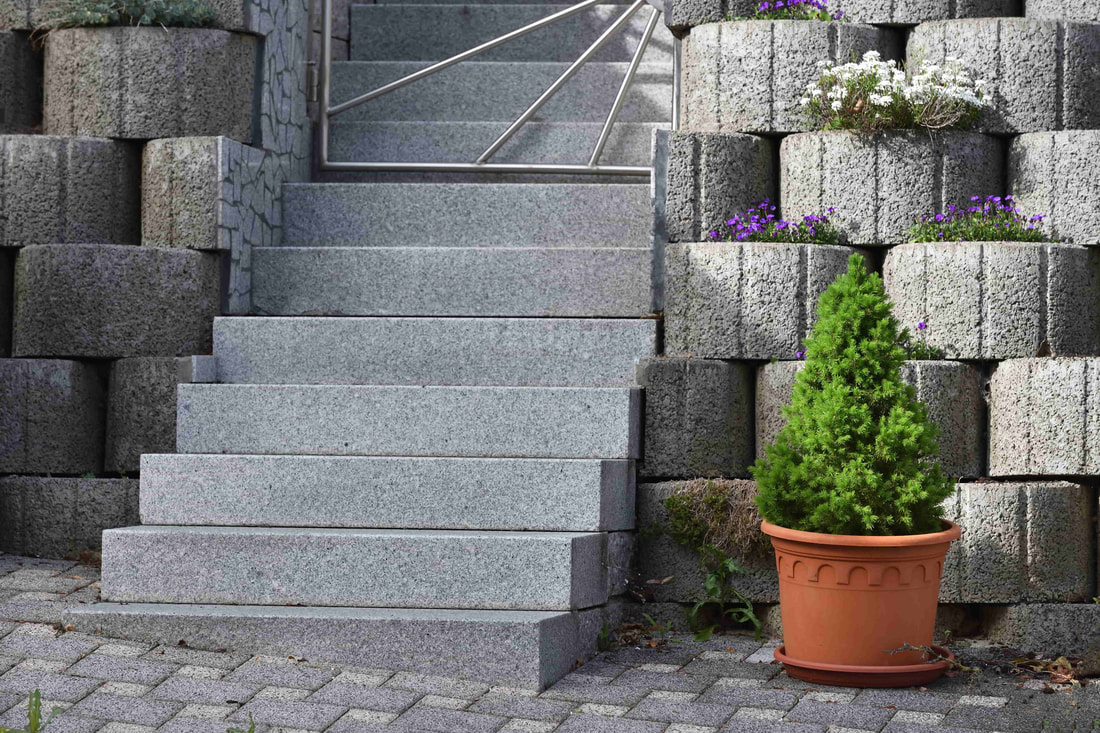 These concrete blocks double up as a retaining wall and pot for plants