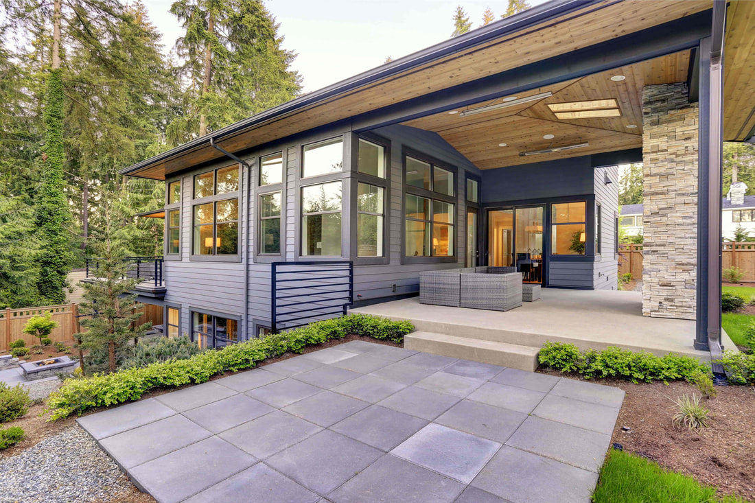 Luxury home in Abbotsford that has a stamped concrete and regular concrete patio.